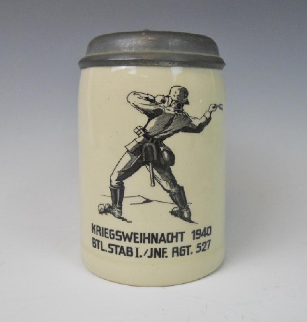 WW2 German Heer Regimental Christmas Stein, 1940: WW2 Original German Christmas Regimental half liter stoneware stein decorated with a German soldier throwing a stick grenade. Stein reads, "KRIEGSWEIHNACHT 1940" and "BTL. STAB I./INF. REG. 527". Hing