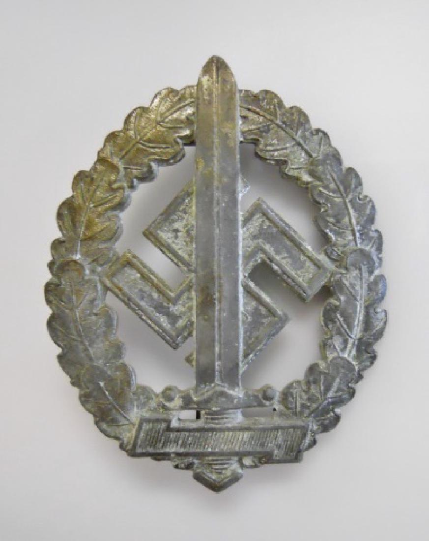 WW2 German SA Defense Badge Disabled, RZM M1/100: WW2 Original German SA defense badge for disabled veterans, signed on reverse RZM M1/100, (Redo). Die struck with silver wash surfaces, brass broad pin, hinge and catch.
