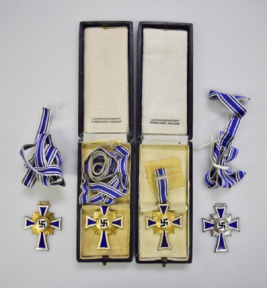 Collection of WW2 German Mother's Crosses, (4pc): WW2 Original German mother's cross. (3) Mother's Cross in gold, die struck with gilt and enamel, reverse marked "16 December 1938" with Adolf Hitler autograph, two cased with blue and white ribbon. ri
