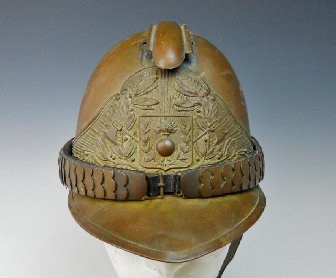 19th C. French Firefighter Helmet: 19th C. French Firefighter helmet. Brass construction with gilt plate which reads, "Srs POMPIERS DE LA CHAPELLE". Brass chin scale, interior with leather liner.