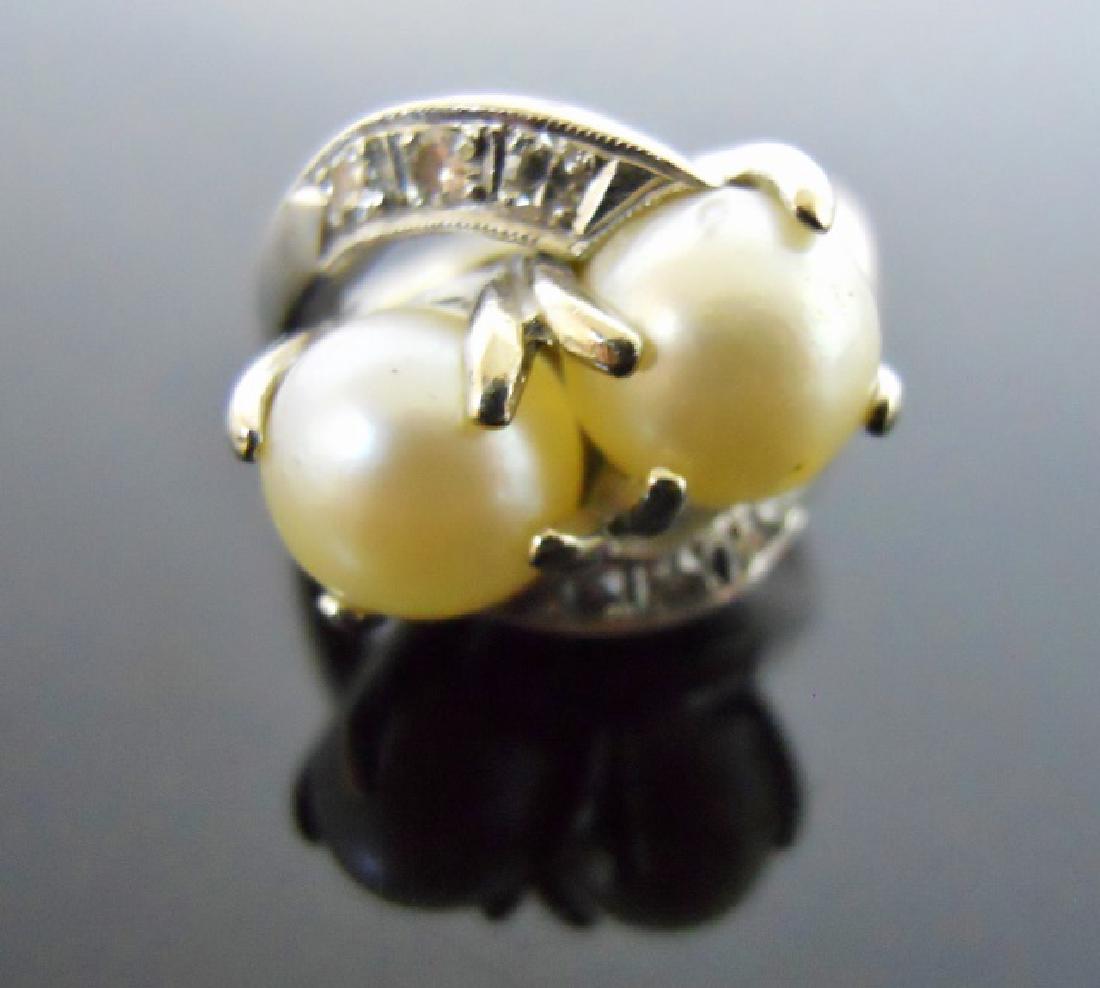 Ladies 14K Gold Diamond, Pearl Ring: 14K White gold ring set with two saltwater pearls, flanked by three round cut diamonds. Total weight, 7.2 g, 4.6 Dwt