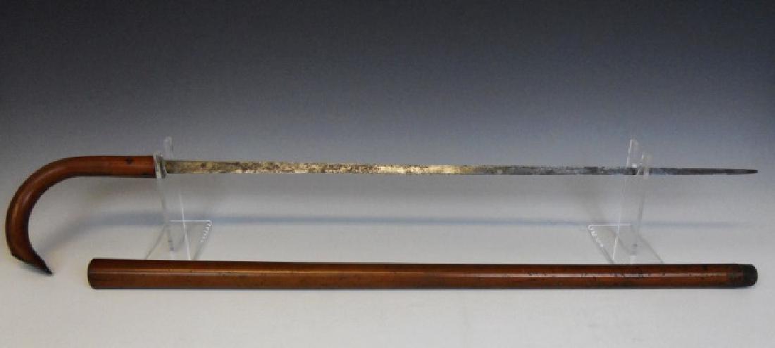 Antique Sword Cane, 1849 Date: Two-piece curved handle wood cane with brass mounted plate engraved, "JJP 1849". Interior fitted with single edged tapered steel sword blade. Cane measures, 34.75" L.