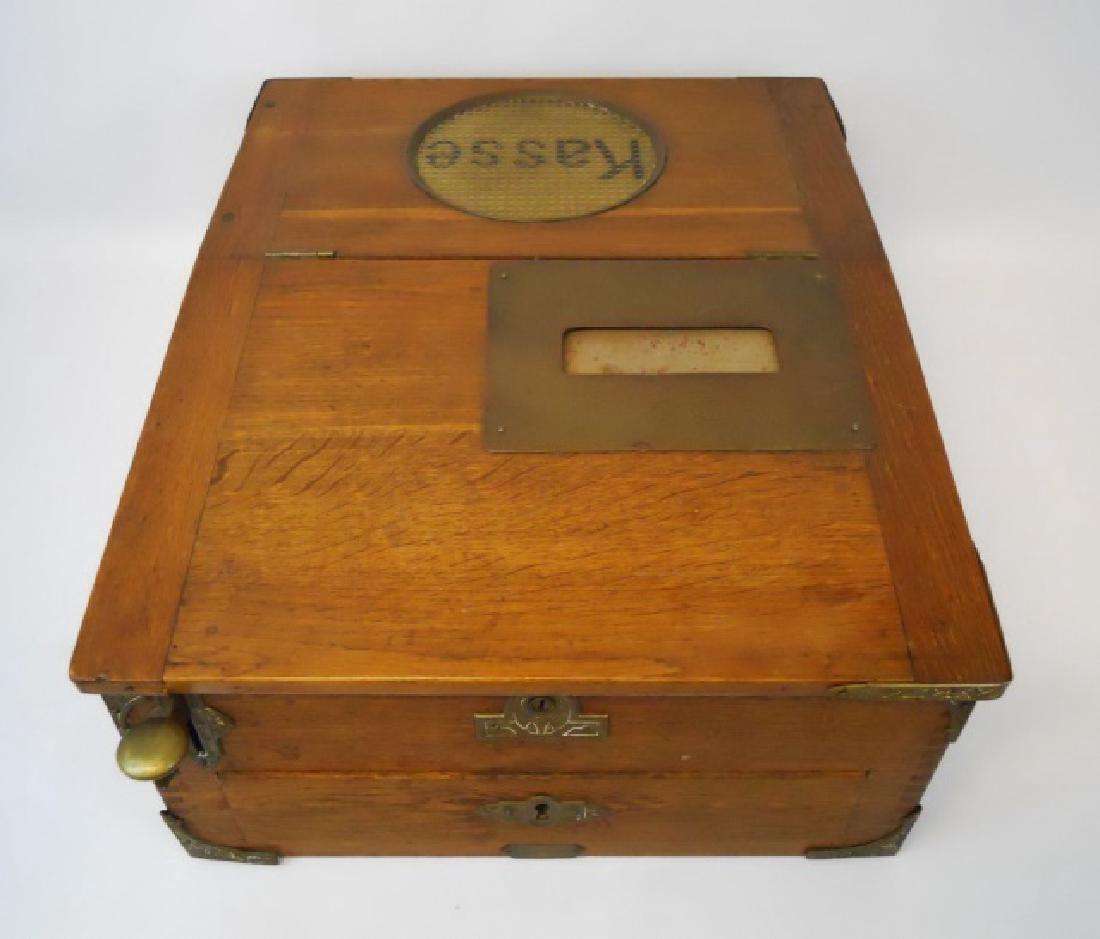 Antique Wooden German Cash Box with Contents: Vintage German wooden Kasse (cash) box with brass hardware. Lever and bell mechanism with sliding drawer in working condition. Circular yellow hobnail glass at top with the word, "Kasse" underneath. M