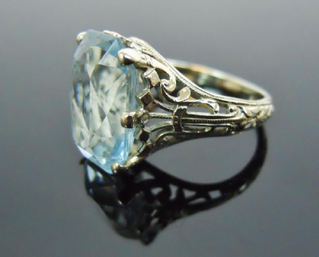 Ladies 14K White Gold Aquamarine Ring: 14K White gold filigree ring set with a large quality radiant cut aquamarine gemstone. Total weight, 3.2 DWT