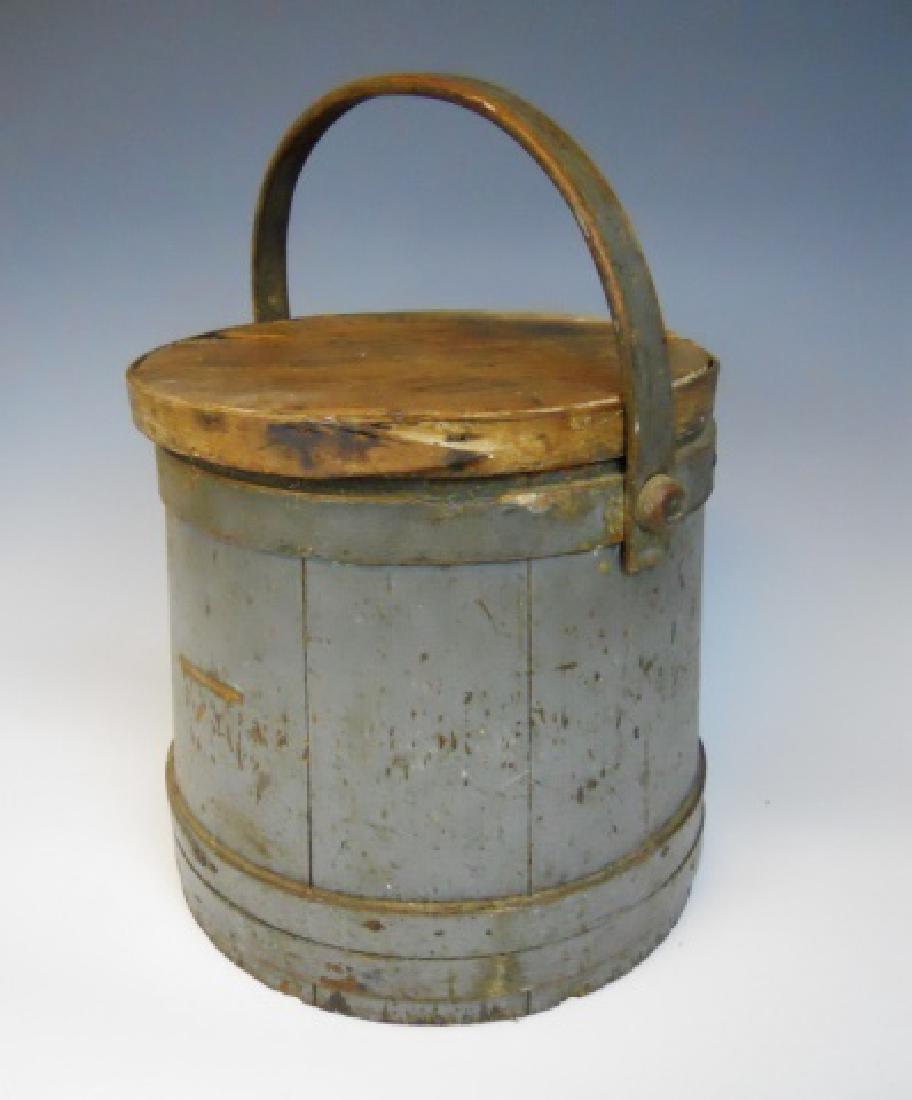 19th C. Firkin in Old Grey Paint: Wooden firkin with lid and bent wood swing handle. Bucket with eight staves, nailed lap bands and fitted cover with illegible stenciled marking, (possibly married.) Old painted grey surfaces. Measures