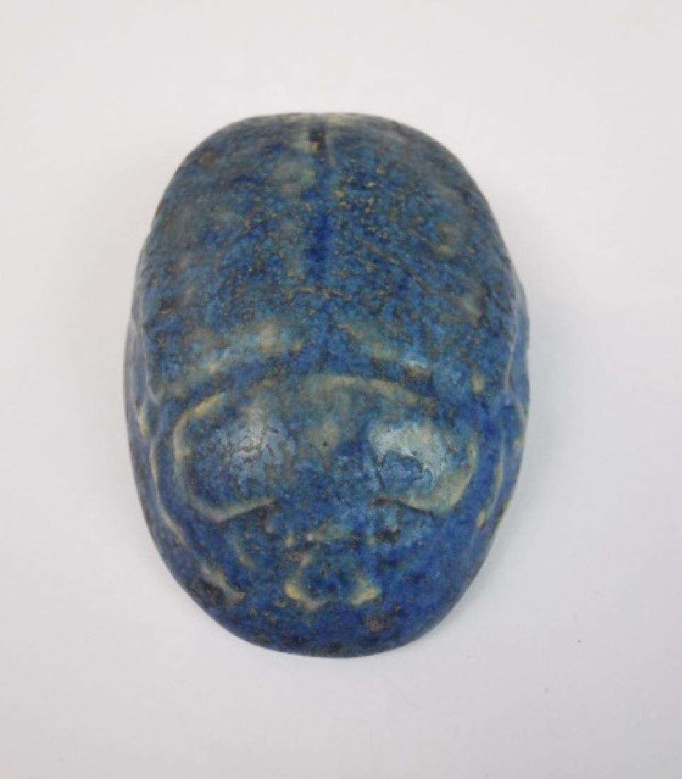 Grueby Pottery Scarab Form Paperweight: Pottery paperweight in scarab form with mottled blue glaze. Base signed with incuse mark, "GRUEBY FAIENCE CO BOSTON USA" with paper label affixed, "GRUEBY POTTERY BOSTON USA". Measures: 2.75" L.