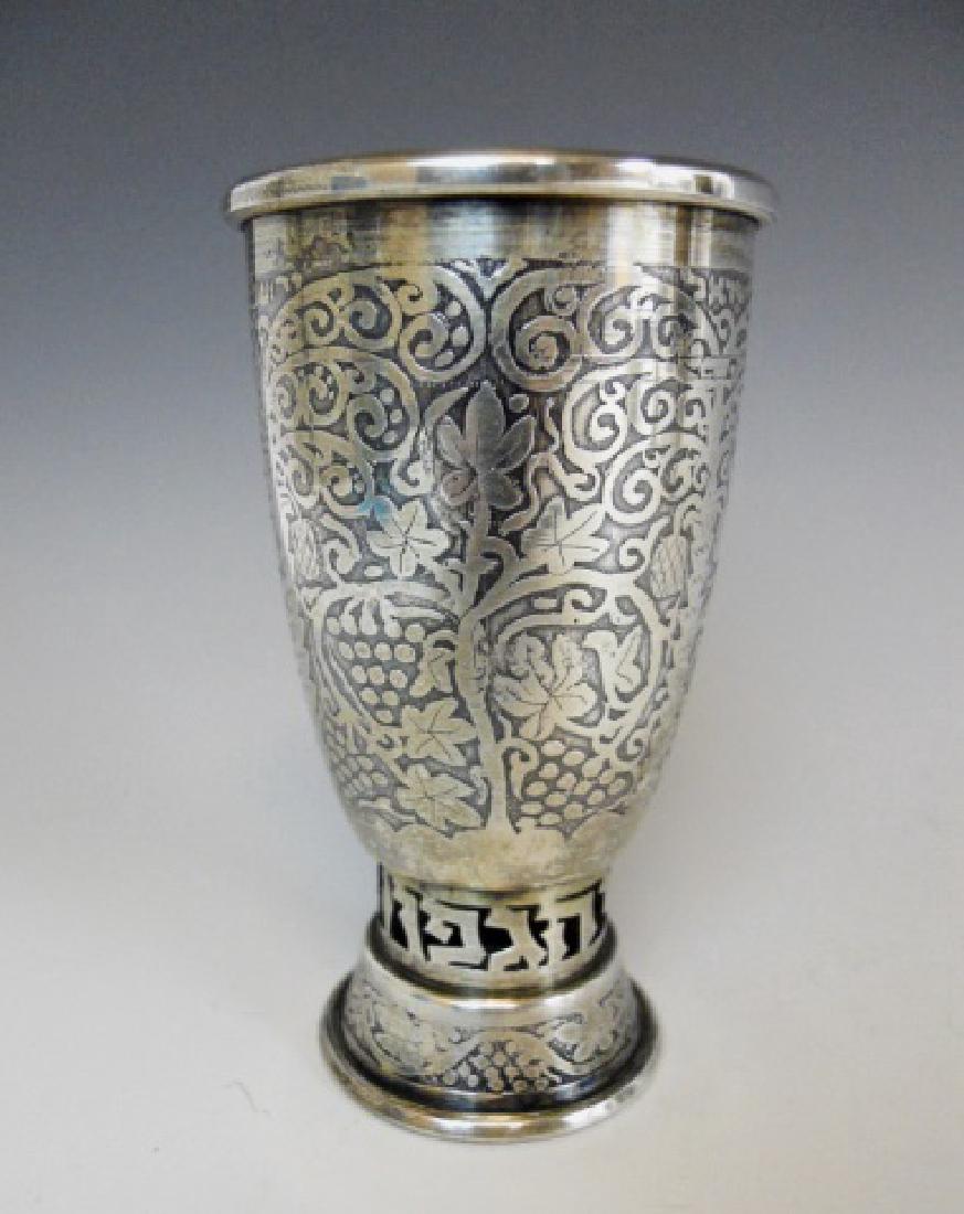 Sterling Silver Kiddush Cup, Israel Bezalel School: Sterling silver cup with etched foliate grape vine decoration. Base with reticulated Hebrew characters. Cup measures, 4.45" H, weight 2.42 Ozt