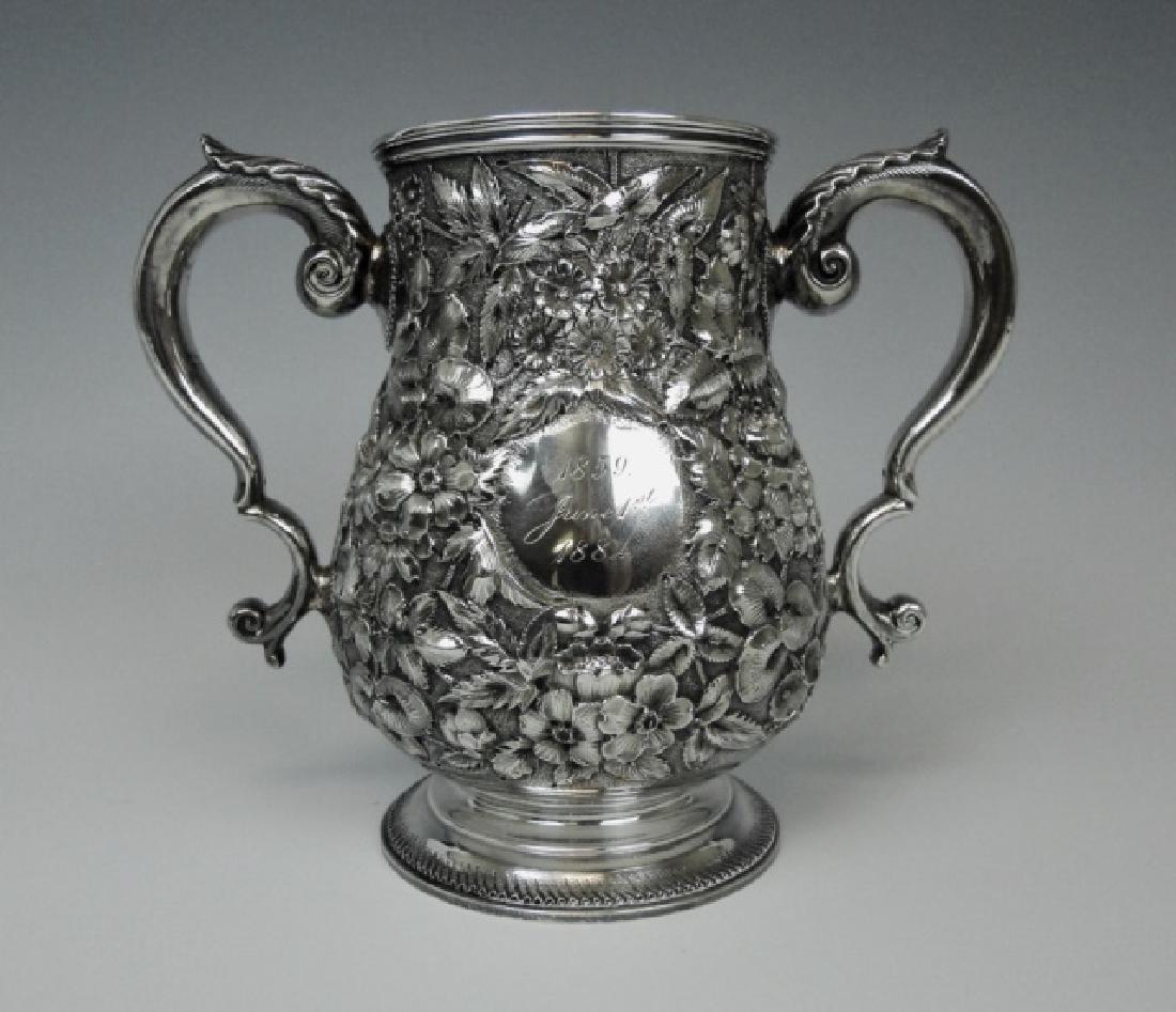 19th C. Sterling Presentation Cup, Bigelow Kennard: Heavy gauge sterling silver presentation cup with hand chased floral repousse decoration, signed "BIGELOW KENNARD & Co MAKERS". Cup with engraved cartouche, "1859 June 1st 1884" base additionally engr