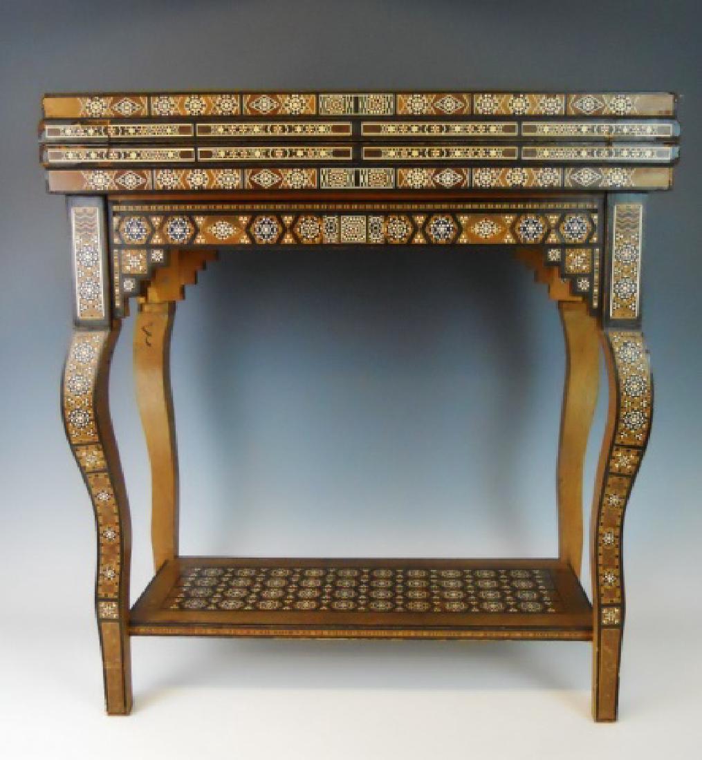 Syrian Parquetry Inlaid Game Table: Syrian parquetry inlaid game table. Profusely decorated in diverse wood, bone, mother of pearl in geometric pattern. Table opens to a backgammon board and chess board. High quality workmanship in exce