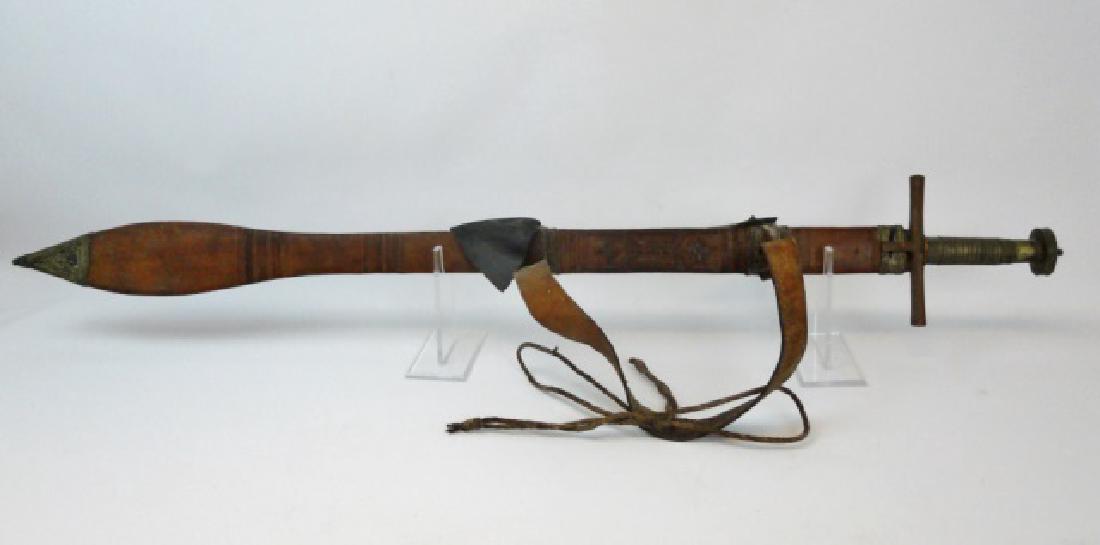 19th C. Sudanese Mahdi Broadsword: 19th C. hand forged Sudanese "Mahdi Army" broadsword with scabbard and hanger. Straight steel blade with spear point tip and partial single fuller. Steel cross guard with metal wrapped wood grip. Tool