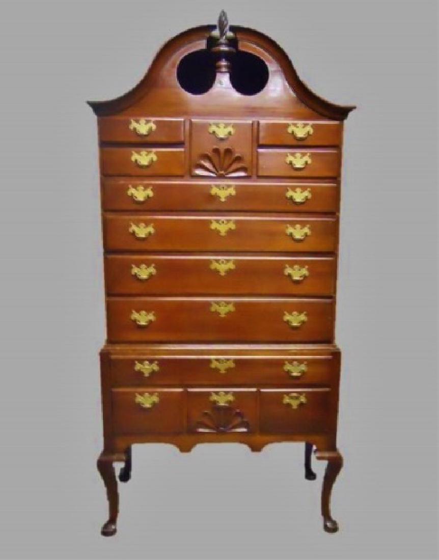 18th C. Chippendale Cherry Bonnet Top Highboy: Circa 1780, American Chippendale highboy chest constructed in cherry wood with two piece dovetailed case. Top with enclosed bonnet top and flame finial with nine drawers and scallop shell carving. Bot
