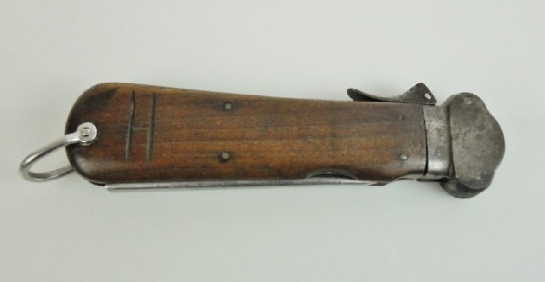 WW2 German Paratrooper Knife, SMF Solingen: WW2 German M1941 Luftwaffe Fallshirmjaeger Messer (Paratrooper Knife). Wartime takedown model with steel framed wood grips, steel bolster and retractable steel blade signed, "SMF SOLINGEN ROSTFREI" wi