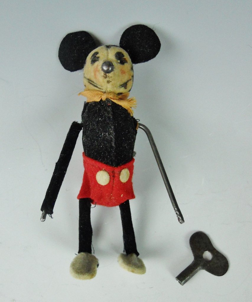 1930's Mickey Mouse Mechanical Toy, SHUCO: 1930's Mechanical tumbling toy Mickey Mouse by Schuco. Flocking missing on left arm. Original key and remnants of box. Works.