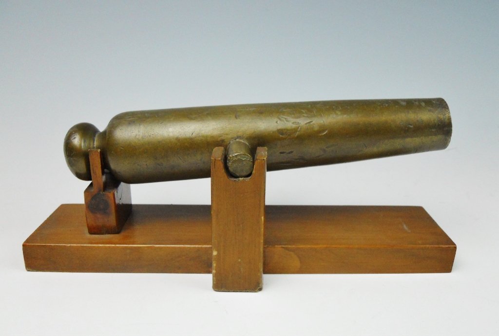 19th C. Brass Ship Signal Cannon: 19th C. brass signal canon with touch hole, trunnions and cascabel. Bore is .61" approximately 20 gauge. Cannon accompanied by later hand crafted wood stand. Cannon measures: 9" L.