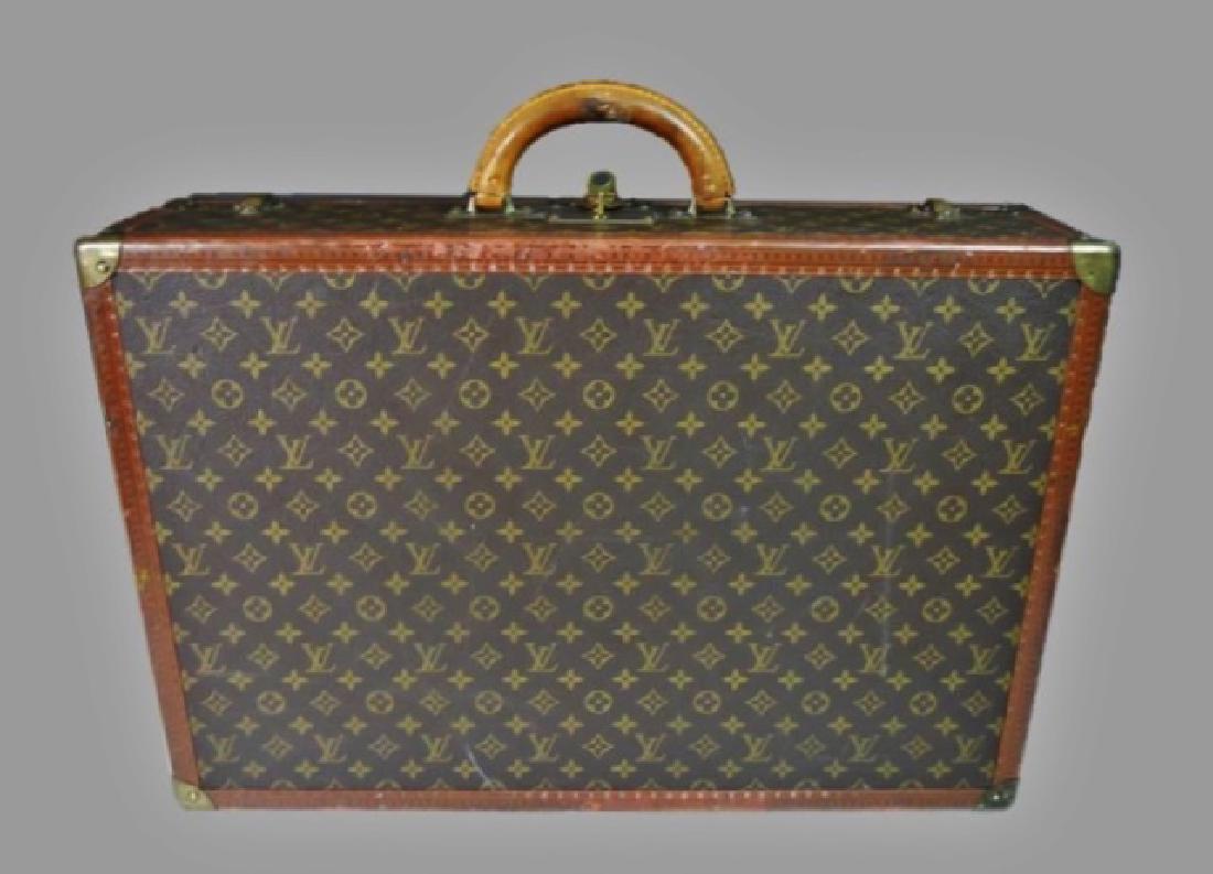 Vintage Hard Side Suitcase, Louis Vuitton: Vintage Louis Vuitton hard sided suitcase. Leather and brass fitted case with traditional "LV" canvas surfaces. Interior with straps, exterior with working lock and key. Excellent overall condition wi