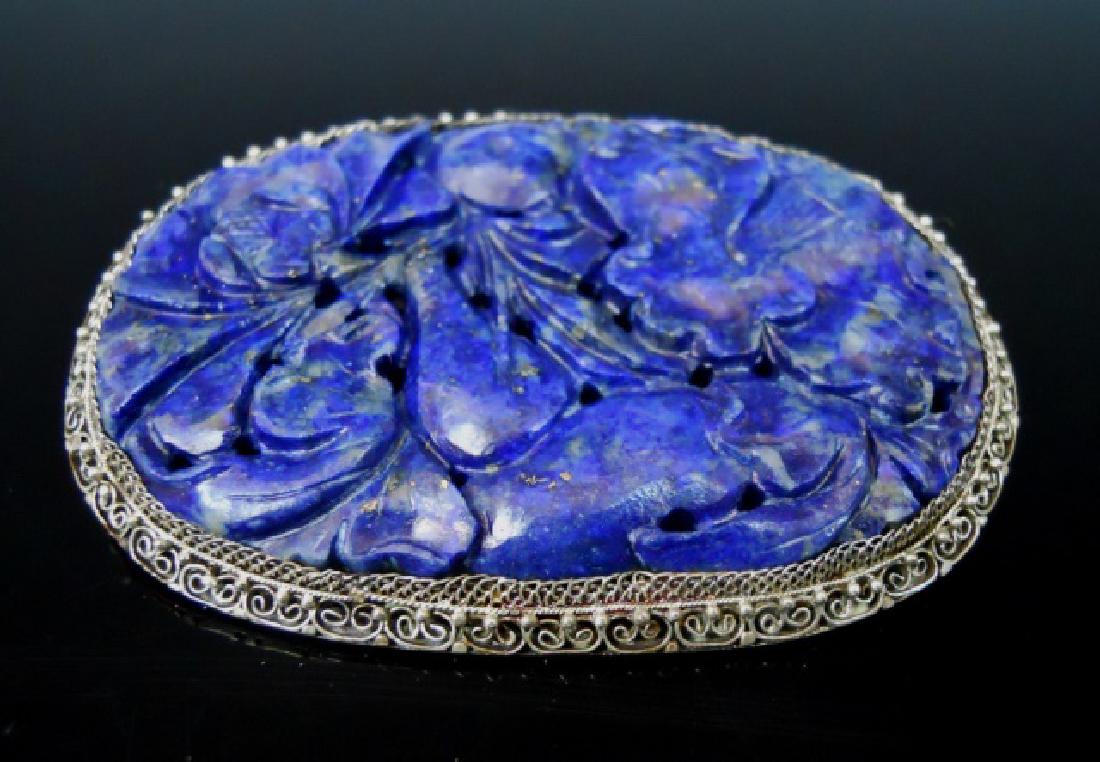 Chinese Silver Filigree Carved Lapis Lazuli Brooch: Chinese silver filigree brooch, set with carved lapis lazuli stone in fruit and foliate design. Brooch measures: 2.5" L, total weight: 20.8 g. Provenance: From the collection of Mrs. Winnie Davis Floy