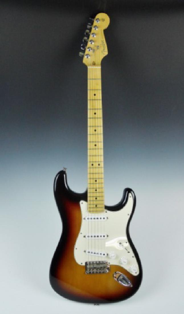 2003 Fender USA Stratocaster Electric Guitar: Electric guitar manufactured in 2003, Fender Stratocaster, made in USA. Body in Tobacco Sunburst finish, maple neck and fret board. Guitar in excellent condition, accompanied by Fender tweed hard case