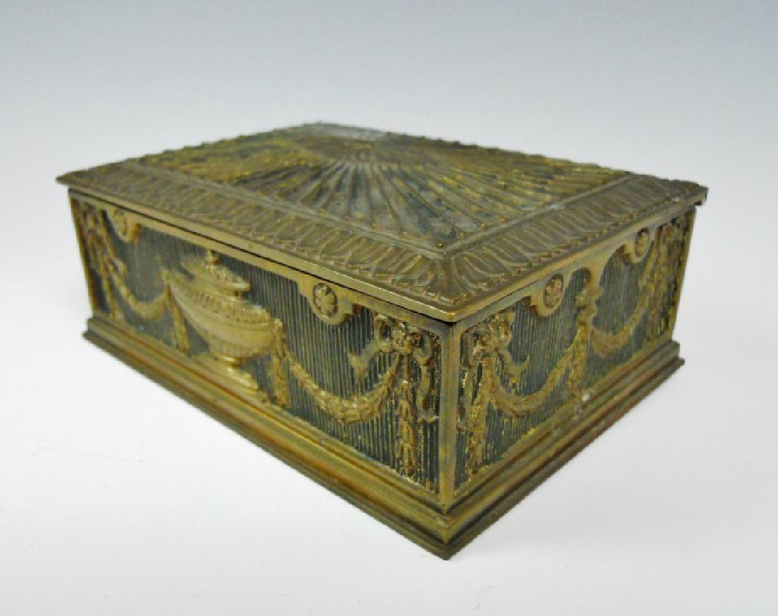 Antique Bronze Trinket Box, Tiffany Studios, NY: Antique cast bronze hinge lidded box with neo-classical design. Box is wood lined and signed on base, "TIFFANY STUDIOS NEW YORK 1854" Box measures: 1.75" H x 4.85" W x 3.6" D.