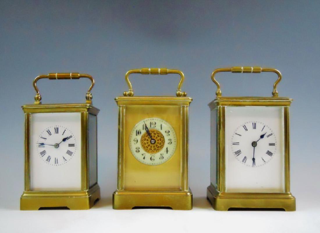 Collection, Antique French Carriage Clocks, (3pc): Collection of three Antique French carriage clocks: (1) Clock with glazed brass case, white enameled face with Roman numeral radial dial. Eight-day time and strike with top escapement window, clock ru