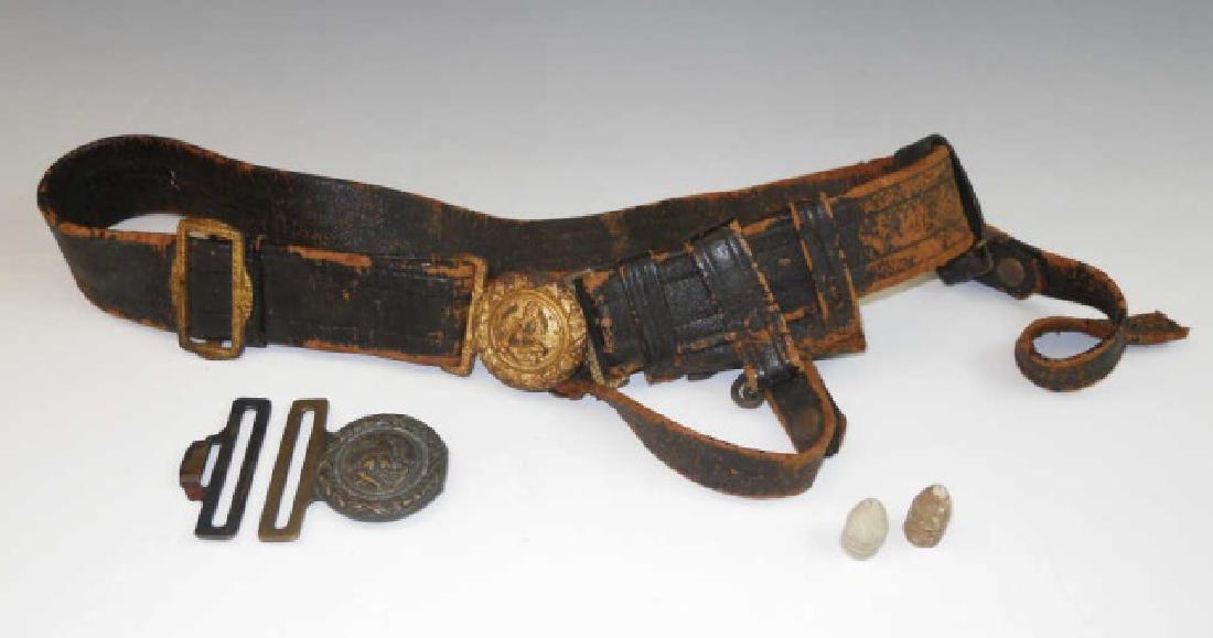 19th C. U.S. Navy Belt and Buckles, (5pc): 19th C. U.S. Navy Officer's leather belt with brass buckle and sword hangers with additional two piece brass Navy buckle accompanied by two mini balls. Belt with wear consistent with age and use.