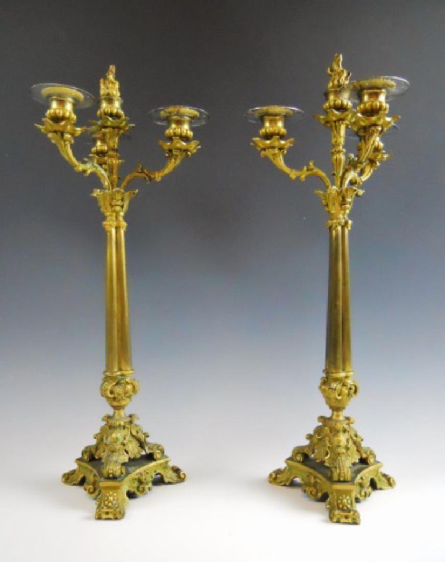 Pair 19th C. French Gilt Bronze Candelabra, (2pc): Pair of French Empire heavy bronze Rococo style candelabra with three branches and center flame finial. Cast bronze with gilt surfaces having hand chased design embellishment. Measure: 20" H.