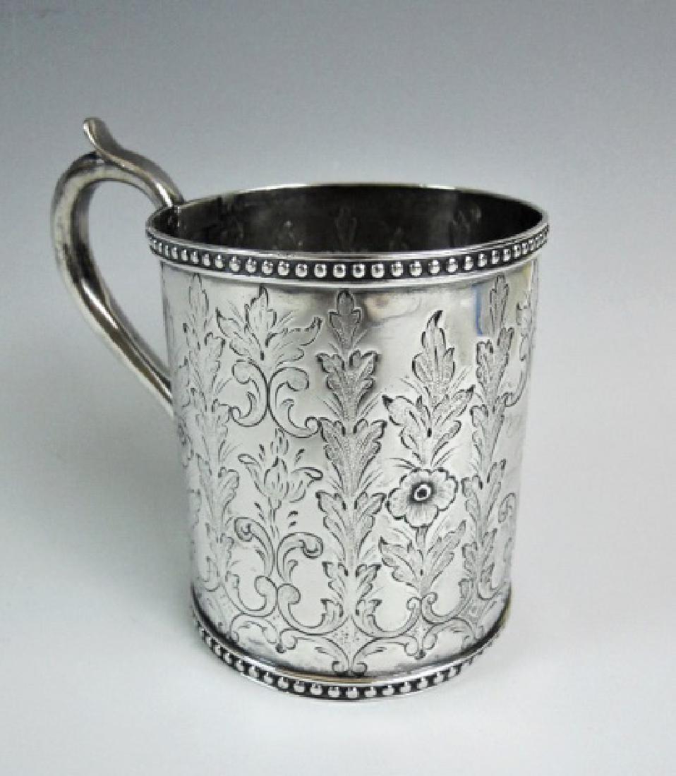 19th C. American Coin Silver Cup, Ball Black & Co: 1850's American coin silver christening cup, signed "BALL BLACK & Co N. YORK". Mug with loop handle and hand chased floral design with beaded edge, central cartouche with dedication, "Alice from my Mo