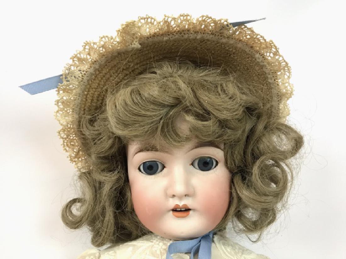 Armand Marseilles Queen Louise, German Doll 28": Marks: Germany, Queen Louise, 10. Doll measures 28" H. Bisque head shows good color overall. The blue, working sleep eyes are accented with red dots in the corners as well as painted lower lashes and