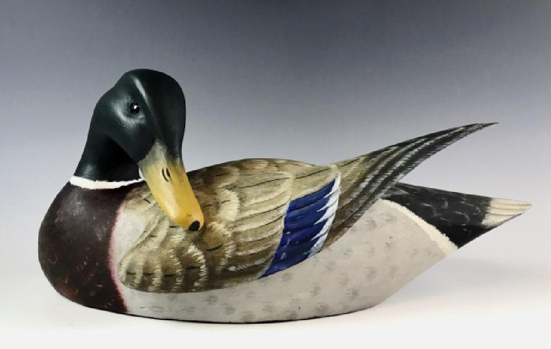 Carved, Preening Mallard Decoy, Brian Mitchell: Hand carved and painted preening Drake Mallard duck decoy, signed "Brian Mitchell 1991" (Brian Mitchell, Plymouth Massachusetts). Skillfully carved decoy with detailed paint and inset glass eyes. Meas