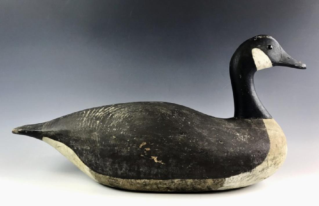 Carved Wood Goose Decoy, Joe Lincoln: Hand carved and painted Canada Goose decoy, Joe Lincoln, Accord Mass. Exceptional form with glass eyes and original paint. Light wear consistent with age and light field use12.5" H x 23.5 L.