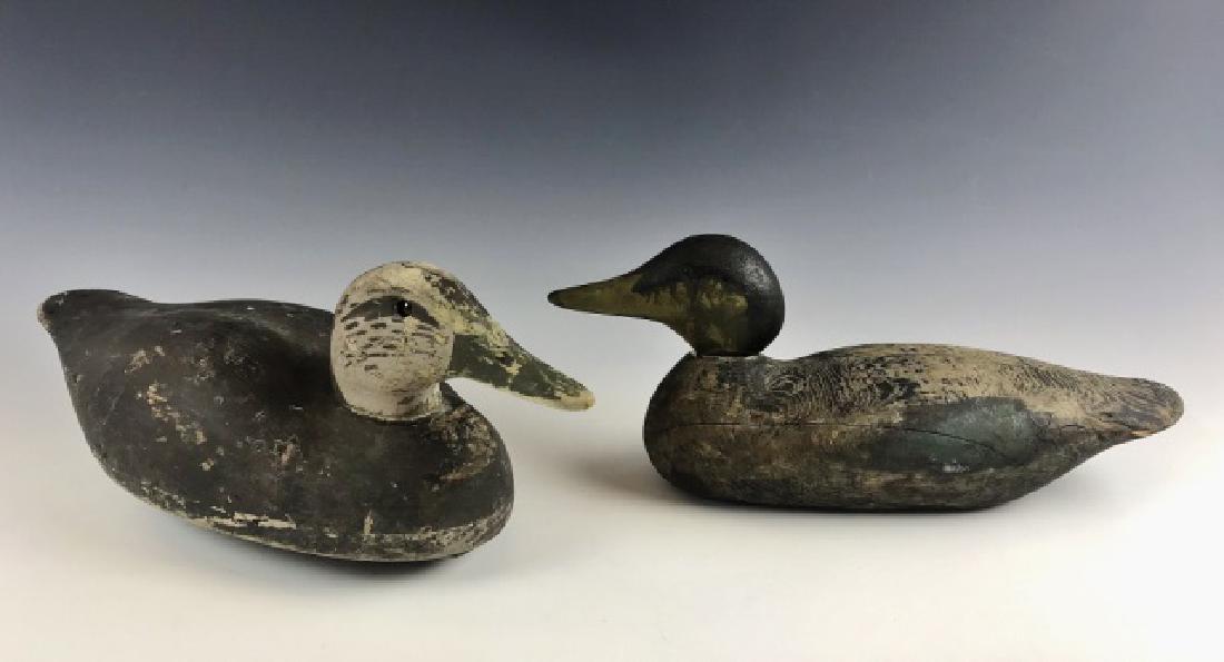 Two Carved, Painted Factory Duck Decoys, (2pc): Two carved and painted factory duck decoys: (1) Mason factory Drake Mallard, measures: 6.5" H x 16" L, (1) Wildfowler glass eyed factory Hen Mallard, measures: 6.75" H x 18" L. Birds with wear consist