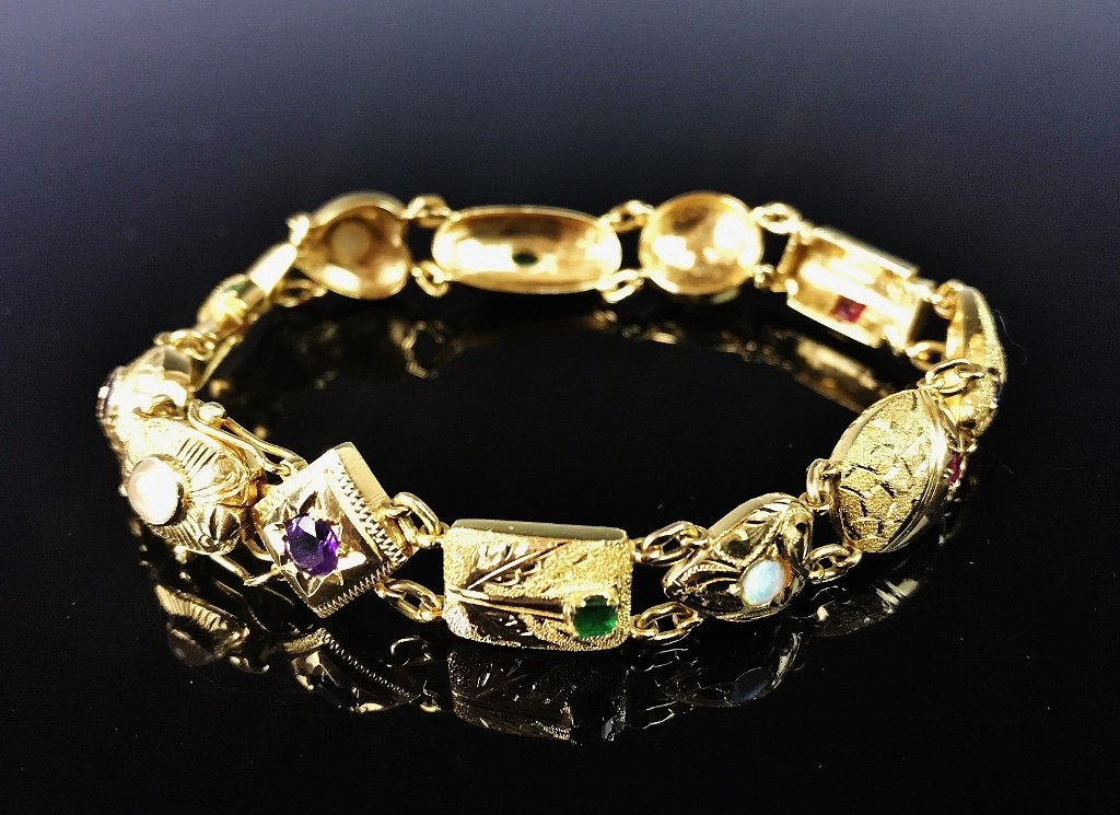 Ladies 18K Gold, Gemstone Bracelet: Ladies 18K yellow gold link bracelet set with faceted and cabouchon gemstones, including diamonds, rubies, emeralds, opals, sapphires and amethyst. Each link is hand embellished and unique to the rest