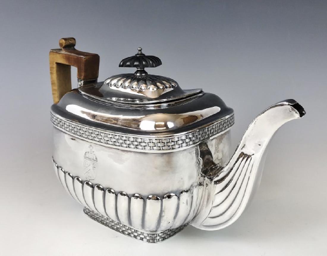 George III Sterling Silver Teapot, John Smith Arms: British sterling silver teapot with hallmarks for London, 1808 date letter and touchmark "DP" (Daniel Popkins,) side emblazoned with the heraldic arms of Captain John Smith and likely was owned by his