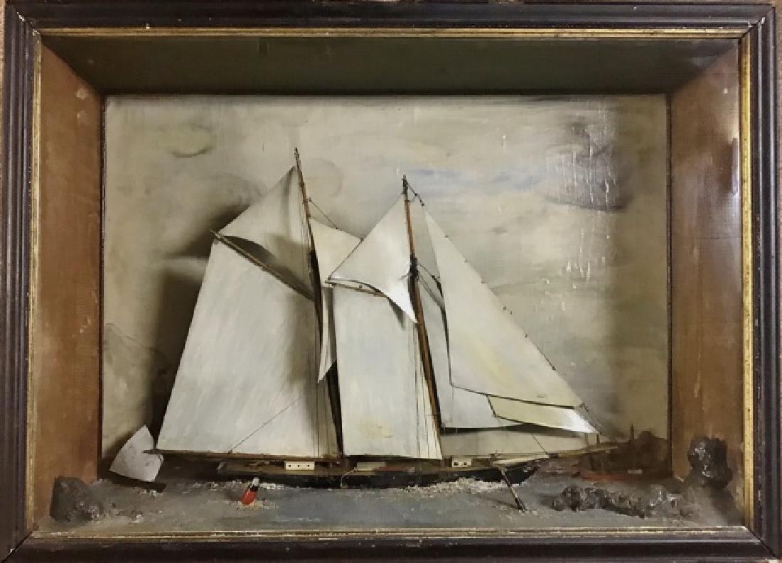Antique Hand Made Folk Art Ship Diorama: Antique hand mage folk art diorama of a sailing vessel passing through a channel. Ship is a two-masted gaffe rigged schooner, smaller vessels in background with hand painted background with lighthouse