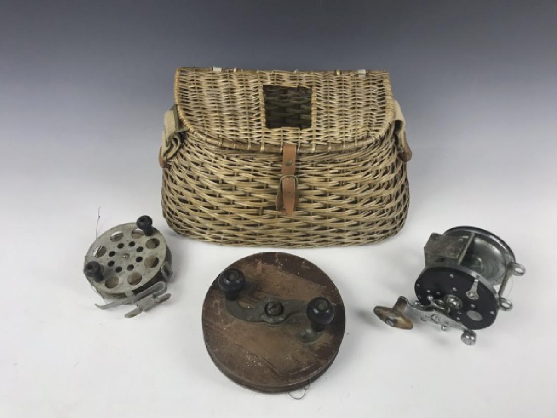 Antique Fishing Collection, Reels, Creel (4pc): Collection of antique fishing gear: (1) Hand woven center hole creel with leather strap, (1) 1950's Penn Senator saltwater reel, (1) Large diameter wooden salmon reel, (1) Metal wire line reel. All in