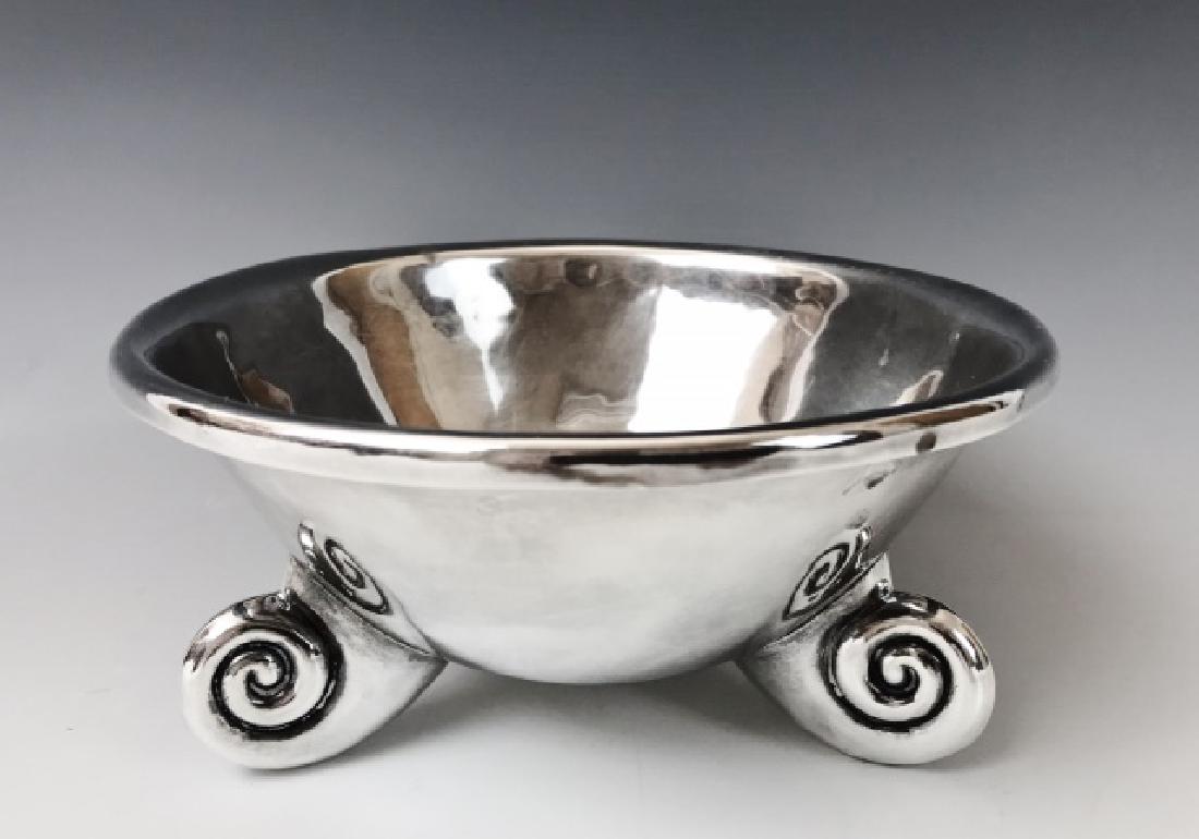 Sterling Silver Bowl, William Spratling, Nautilus: Hand made sterling silver bowl, signed "WILLIAM SPRATLING TAXTO MEXICO". Bowl is hand hammered with stylized nautilus style tripod feet. Measures: 3.25" H x 6.8" W. Total weight 10.26 Ozt.
