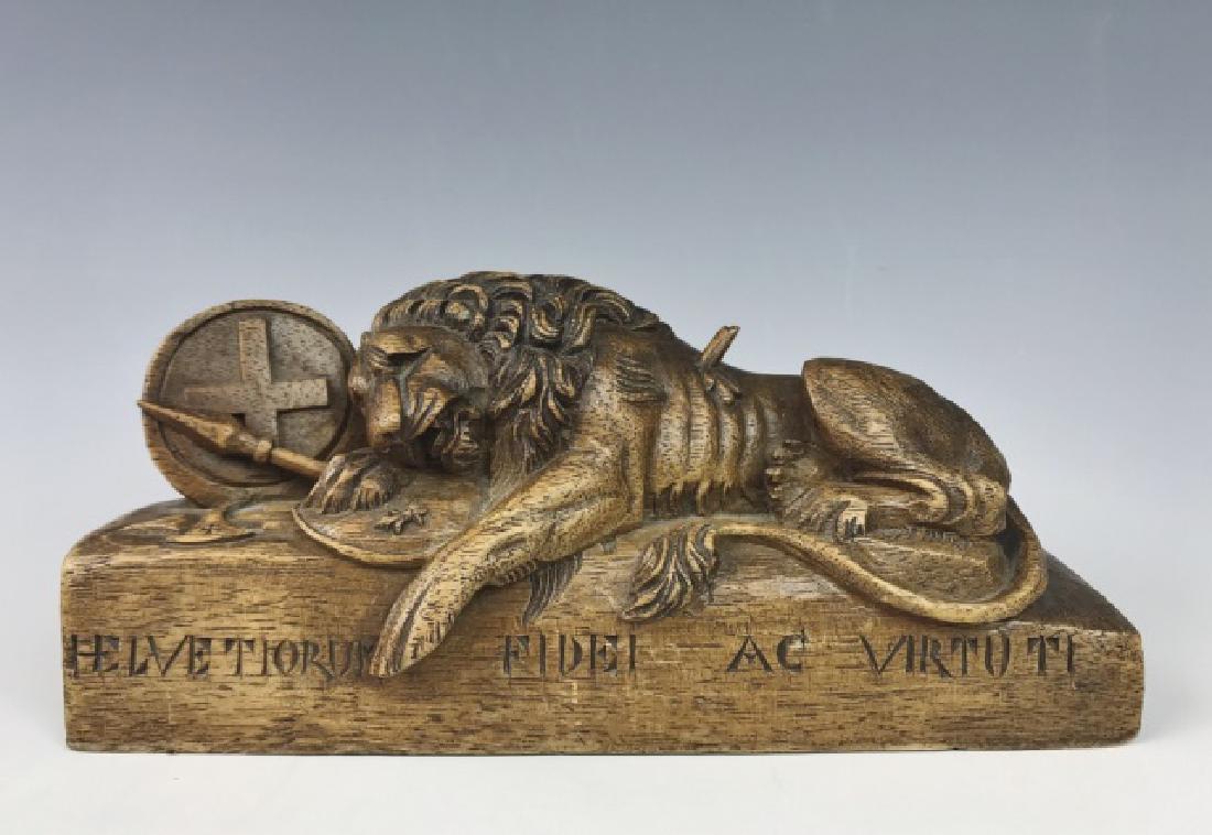 Swiss Hand Carved Wood Figure of Lion, Shield: Skillfully hand carved figure of Swiss lion with shield and spear with tableaux below which reads: "HELVETIORUM FIDEI AC VIRTUTI". Measures: 3" H x 7.75" W.