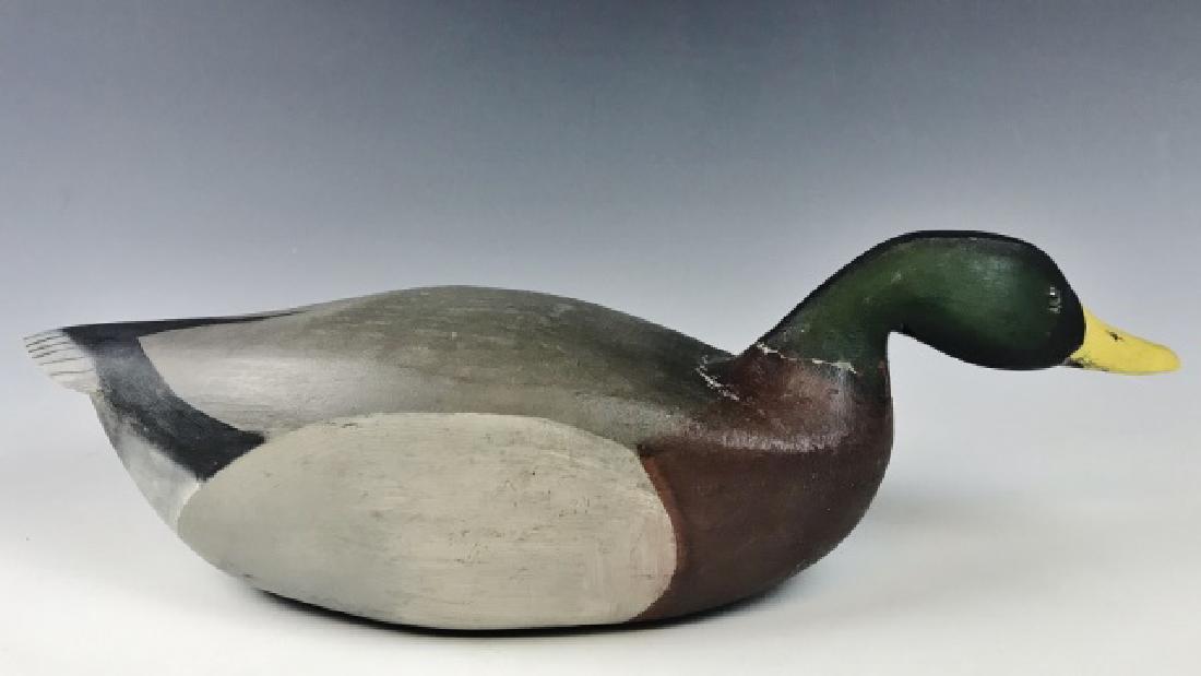 Vintage Swimming Mallard Drake Duck Decoy: Hand carved and painted swimming Mallard Drake. Hollow body with glass eyes, brass owner tag affixed to base "T.W. ESHENBAUGH". Decoy measures: 6" H x 20.5" L.