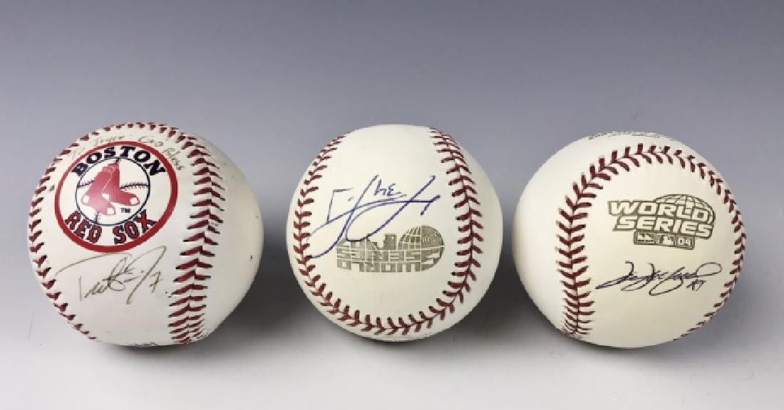 Boston Red Sox Autographed Baseballs, (3pc): Collection of Boston Red Sox autographed baseballs: (1) 2004 World Series ball signed in ink by Red Sox pitcher Tim Wakefield, (1) 2007 World Series baseball signed in ink by Red Sox player David Orti