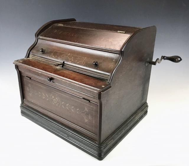 Antique Music Player, Mechanical Orguinette Co: 19th C. hand cranked music player, signed "Mechanical Orguinette Co, New York. Mahogany case with interior rolling mechanism and hand crank. Measures: 14" H x 15" W x 13" D.