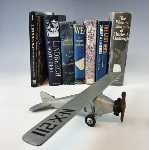 Aviation History US Charles Lindbergh Group (9pc): Aviation History US Charles A. Lindbergh group (9pc). This lot is highlighted by (1) a handmade wooden model, likely done at the time of Lindbergh's famous New York-Paris solo flight in May 1927. Wing