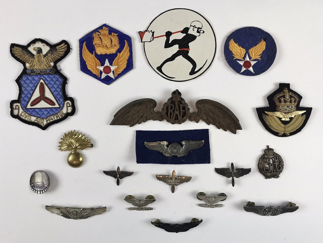 Collection, WW2 US, British Insignia, (18pc): Collection of eighteen World War Two US and British military insignia: (1) Hand carved wooden winged RAF emblem, (1) Printed paperboard squadron patch, (2) USAAF patches, (1) Civil Air Patrol patch, (