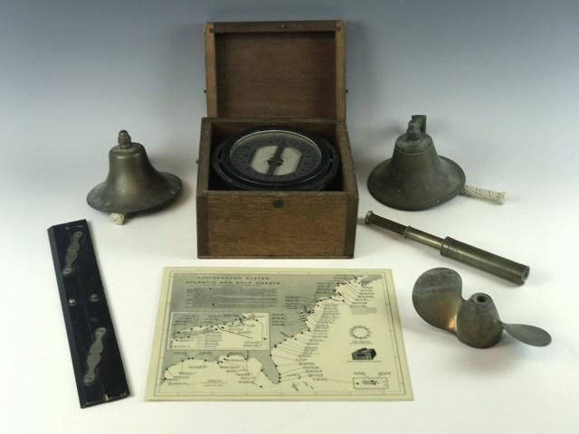 Collection of Maritime Items, (7pc): Collection of seven antique and vintage maritime items: (1) Brass two bladed propeller, 8" D, (2) Brass deck bells, 6" D, (1) Antique wood and brass chart divider, (1) Wooden cased gimbaled lifeboat c