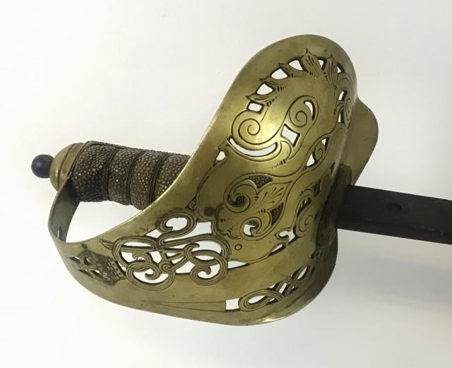 Antique British George V Officer's Sword: Antique British sword with straight single fullered blade with reticulated brass guard with George V Royal Cypher and foliate design and shagreen grip. Ricasso with proof. Sword measures: 38.5" L.