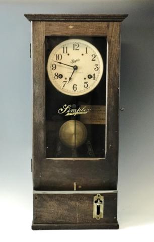 Antique Punch Card Time Clock, Simplex: Early 20th C. Puch Card Time Clock, signed "Simplex Time Recorder Company". Oak case with glass panel door. Key wind movement with integrated time stamp mechanism. Arabic numeral radial dial with hour