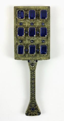 19th C. Neoclassical Gilt Bronze Hand Mirror: 19th C. decorative hand mirror in gilt bronze. Neoclassical design with detailed filigree, set with blue faceted crystal prisms and beveled glass mirror. Measures: 13.25" L x 4.25" W.