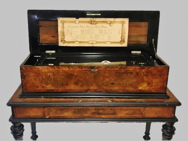 19th C. Swiss Cylinder Music Box, Excelsior: 19th C. Swiss music box, "Excelsior Interchangeable Cylinder Music Box". Marquetry veneer lidded case and stand with ebonized embellishment. Glass internal cover reveals complex internal works with fo