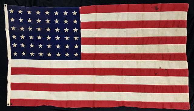 WW2 American Flag, Provenance U.S.S Ranger, VJ Day: World war two forty-eight star sewn flag. Flag accompanied by typed paper, reads: "This Flag Flew on the U. S. S. Ranger an Aircraft Carrier on the 14th of Aug. 1945 on V-J Day, the surrender of the J