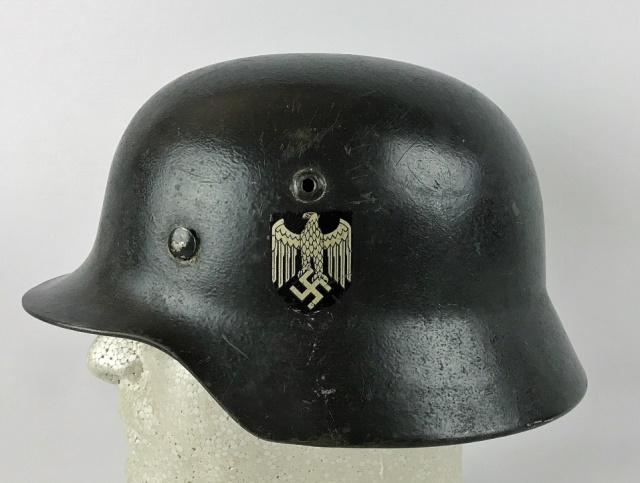 WW2 German Heer Single Decal Combat Helmet: World War Two German Heer M1935 Combat Helmet. Reissue steel helmet with single black and silver eagle decal with thick dark grey paint over original factory green paint, remnants of tri color decal v