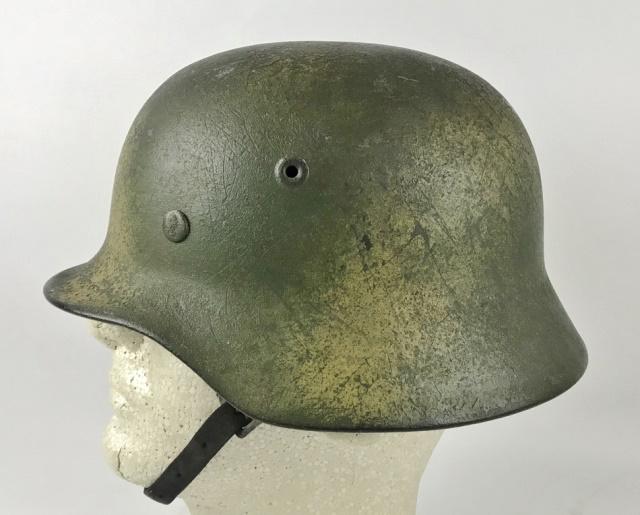 WW2 German Heer Camouflage Combat Helmet: World War Two German Heer M1935 Combat Helmet. Steel helmet with two color camouflage paint scheme in green and sprayed yellow- tan, over original factory green paint. Rolled rim with multi piece ear 