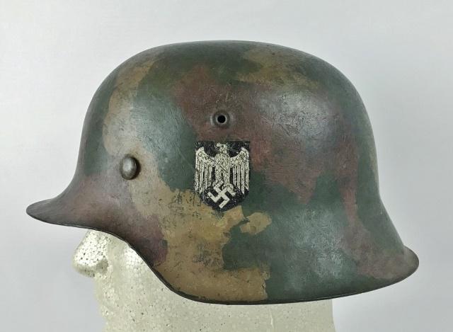 WW2 German Heer Camouflage Combat Helmet: World War Two German Heer M1942 Combat Helmet. Steel helmet with three color camouflage paint scheme in green, brown and tan over original factory grey paint with single black and silver eagle insigni